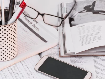 pens-smartphone-copybooks-near-glasses